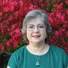 Christine Lennips profile picture - green shirt with red leaves background Christine Lennips profile picture - green shirt with red leaves background